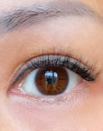 Close-up of a brown eye with detailed self adhesive eyelashes