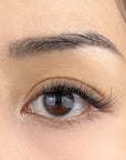 close up of a round eye with fluffy false lashes in natural style