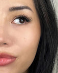 woman wearing dramatic and full volume cluster lashes