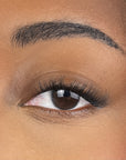 close up of womans eyes with false lashes showing dark lash line and light fluffy tips