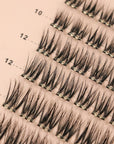 close up of self adhesive cluster lashes on a pink card back ground