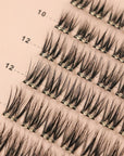close up of self adhesive cluster lashes on a pink card back ground