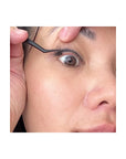 woman putting on pre glued lash clusters
