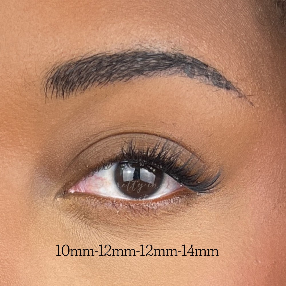 close up of womans eye showing false lash clusters on 2/3 of outer eye.