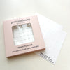 Pink box of lash cluster glue strips with a white background