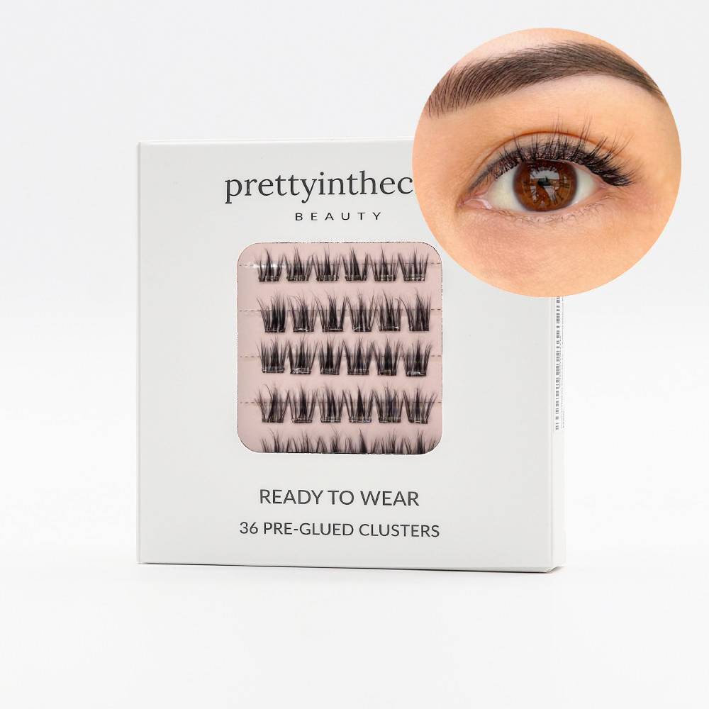 Eyelash packaging with a close-up of an eye wearing the press on lashes on a white background