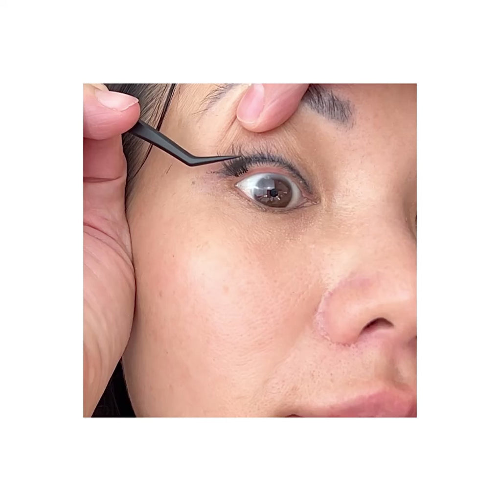 woman putting on pre glued lash clusters